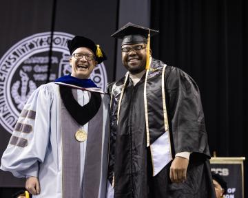 (Left to Right) Regent VanDriel smiles with UCCS student Axel Brown