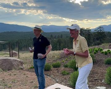 (Left) Regent Vandriel plays a friendly game of cornhole with (Right) Regent Smith at the 2024 summer Regent retreat