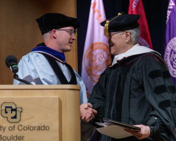 (Left) Regent Mark VanDriel shakes the hand of Regent Award winner.